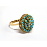 A TURQUOISE FOUR TIER ROUND CLUSTER YELLOW GOLD RING the cluster comprising small round cabochon cut
