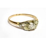 A DIAMOND SOLITAIRE 14 CARAT GOLD RING with small diamonds to shoulders, the round brilliant cut