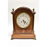 AN EDWARDIAN BRASS MOUNTED 8-DAY MANTLE CLOCK the mahogany case with marquetry inlaid decoration,