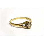 A DIAMOND SOLIATIRE 18 CARAT GOLD RING the round brilliant cut diamond rub over set, weighing