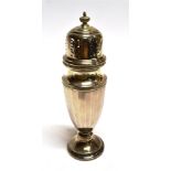 A SILVER SUGAR CASTER of tapered faceted form on pedestal base, hallmarked Birmingham 1935, makers