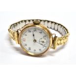 A LADIES 9 CARAT GOLD VINTAGE WRISTWATCH on a plated expanding bracelet, round white dial with