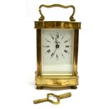 A FRENCH 8-DAY CARRIAGE CLOCK IN SERPENTINE FRONT LACQUERED BRASS CASE the enamel dial with Roman