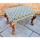 AN UPHOLSTERED STOOL on carved fruitwood braganza supports, 63cm x 45cm, 50cm high
