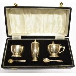 A BOXED SILVER THREE PIECE CONDIMENT SET AND TWO MATCHED SALT SPOONS condiment comprising salt,
