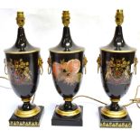 THREE MATCHING TOLEWARE TABLE LAMPS two decorated with coats of arms, the htird with floral