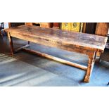 A RUSTIC REFECTORY DINING TABLE the substantial six plank top with cleated ends, on turned