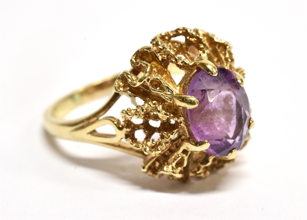 AN AMETHYST SINGLE STONE SET 9 CARAT GOLD DRESS RING the oval mixed cut amethyst approx. 10mm x 8mm,