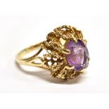 AN AMETHYST SINGLE STONE SET 9 CARAT GOLD DRESS RING the oval mixed cut amethyst approx. 10mm x 8mm,