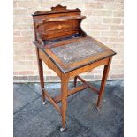 AN EDWARDIAN ROSEWOOD DESK with marquetry inlaid decoration, on square tapering supports with