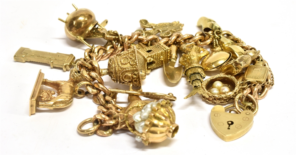 A 9 CARAT GOLD CHARM BRACELET WITH PADLOCK FASTENER containing nineteen assorted charms, - Image 2 of 2