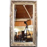 A LARGE GILT FRAMED BEVEL EDGED WALL MIRROR 83cm x 143cm overall