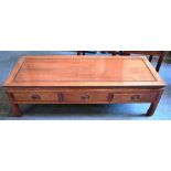 A CHINESE HARDWOOD COFFEE TABLE with three frieze drawers, 53cm x 137cm, 40cm high; together with
