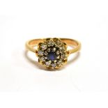 AN 18 CARAT GOLD SAPPHIRE AND DIAMOND ROUND CLUSTER RING the round cut blue sapphire approx. 4mm