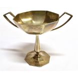 A SILVER TWO HANDLED SMALL TROPHY STYLE CUP of plain faceted design, with angular handles,