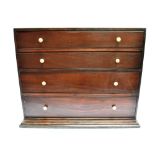 A MAHOGANY TABLE TOP COLLECTORS CABINET with four long graduated drawers, 47cm wide