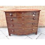 A 19TH CENTURY MAHOGANY BOW FRONT CHEST OF THREE SHORT AND THREE LONG DRAWERS with bone escutcheons,