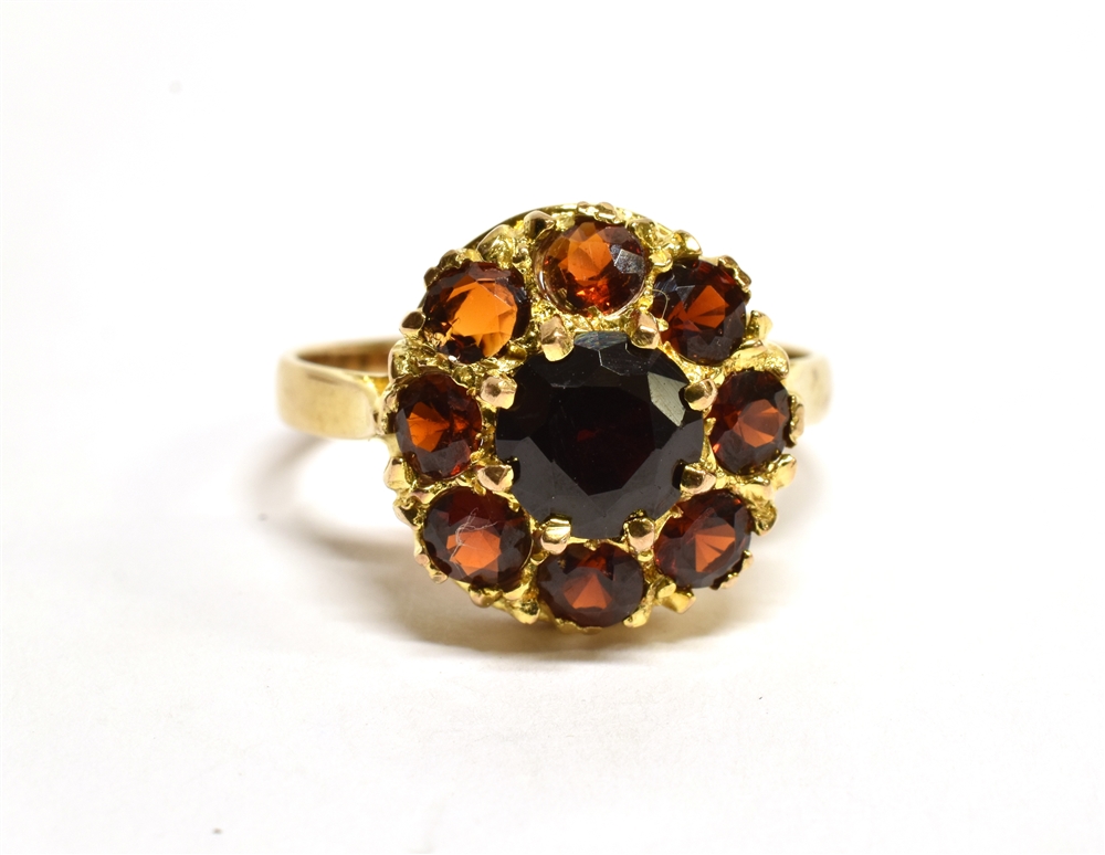 A GARNET ROUND CLUSTER 9 CARAT GOLD DRESS RING central round mixed cut red garnet 6mm diameter,