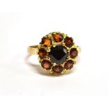 A GARNET ROUND CLUSTER 9 CARAT GOLD DRESS RING central round mixed cut red garnet 6mm diameter,