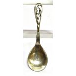 A GEORG JENSEN SILVER SPOON in the pea pod design, with hammered bowl and curved openwork stem,