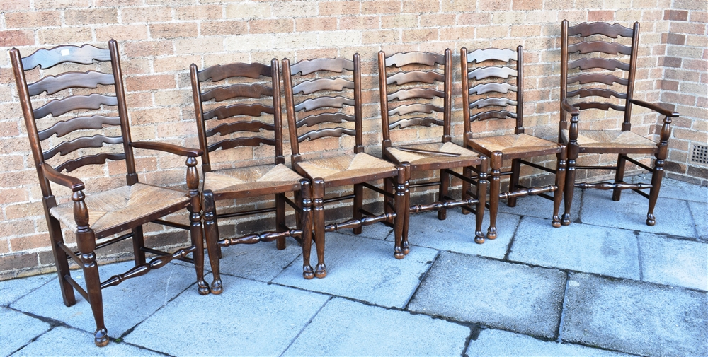 A SET OF SIX RUSH SEAT LADDERBACK DINING CHAIRS including a pair of carvers