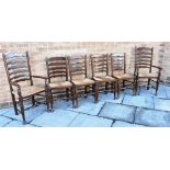 A SET OF SIX RUSH SEAT LADDERBACK DINING CHAIRS including a pair of carvers