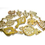 A COLLECTION OF TWELVE VICTORIAN BRASS TRIVETS