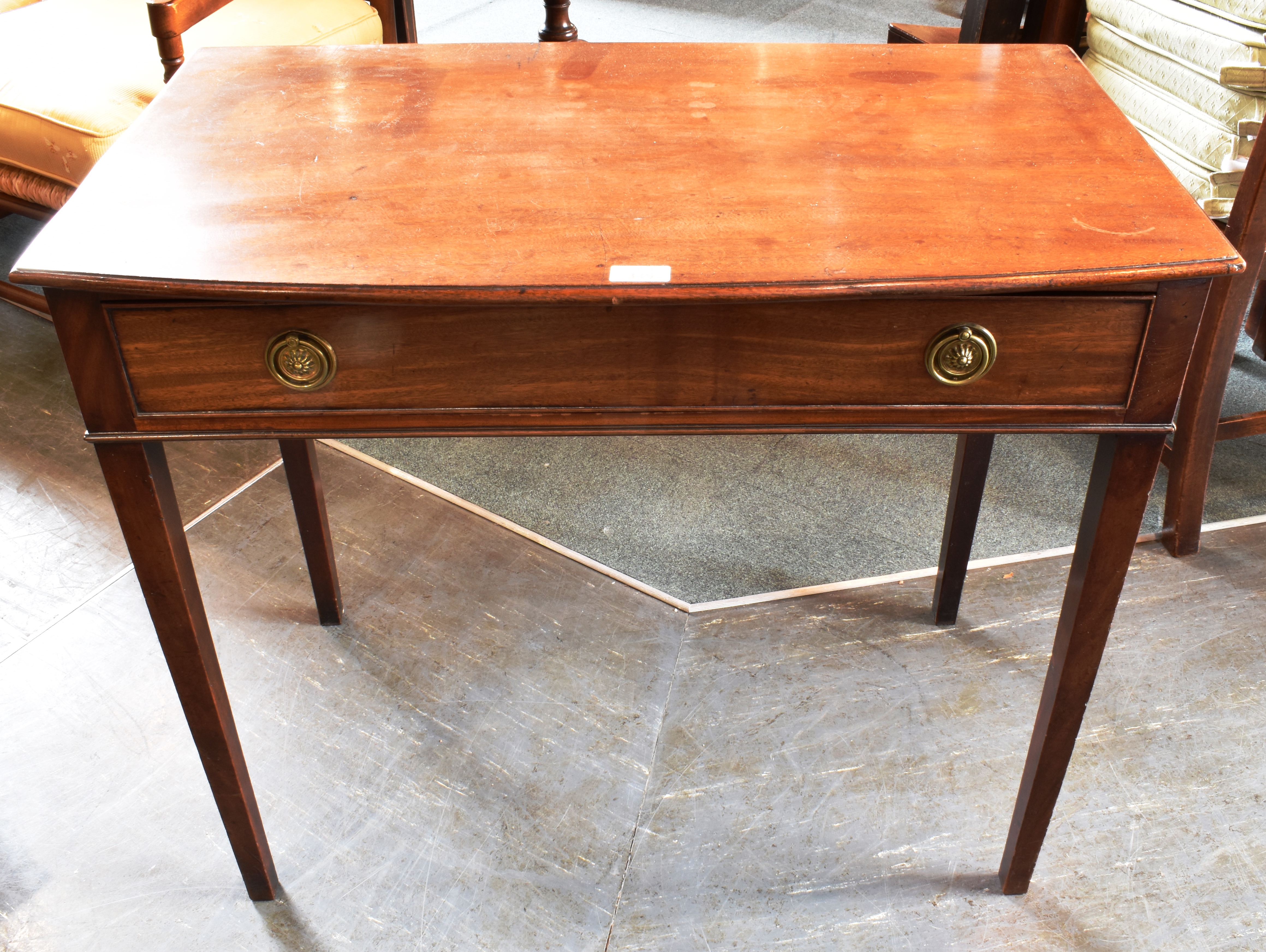 A 19TH CENTURY MAHOGANY SIDE TABLE the top with moulded edge and shaped front, single frieze