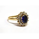 A SYNTHETIC BLUE SAPPHIRE AND CUBIC ZIRCONIA OVAL CLUSTER 9 CARAT GOLD RING ring size N ½, gross