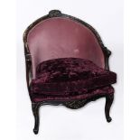 A LARGE LOUIS XVI STYLE FAUTEUIL with ebonised frame, purple upholstery and loose cushion