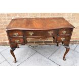 A SERPENTINE FRONT MAHOGANY SIDEBOARD fitted with central drawer flanked by pair of drawers to