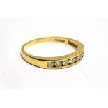 AN 18 CARAT GOLD HALF ETERNITY RING the front channel set section comprising eight small round