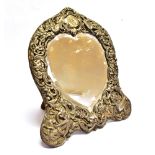 A SILVER FRONTED MIRROR WITH EASEL STAND the heart shaped glass mirror surrounded with silver bird