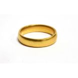 A HALLMARKED 22CT GOLD PLAIN WEDDING BAND the D profile band 4mm wide, ring size L½, weighing 5.2