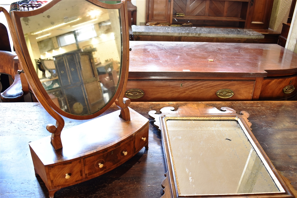 A MAHOGANY DRESSING TABLE MIRROR with shield shaped mirror, the bow front base fitted with three