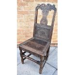 AN OAK HALL CHAIR WITH CARVED DECORATION