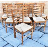 A SET OF EIGHT MATCHING RUSH SEATED LADDERBACK DINING CHAIRS
