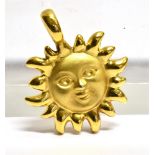 A 9 CARAT GOLD SMILING SUN PENDANT the textured finish round face to plain polished border rays,