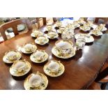 A LARGE COLLECTION OF COPELAND SPODE TEAWARES with painted floral decoration on an ochre ground,