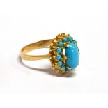 A TURQUOISE OVAL CLUSTER YELLOW GOLD RING the central oval cabochon cut turquoise approx. 10mm x