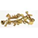 A 9 CARAT GOLD CHARM BRACELET WITH PADLOCK FASTENER containing nineteen assorted charms,