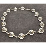 A ROCK CRYSTAL NECKLACE the single row necklace comprising sixteen round spheres of rock crystal