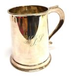 A SILVER MUG the cylindrical form silver mug with flat spreading base, C scroll handle, hallmarked