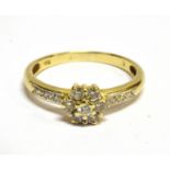A DIAMOND FLOWER HEAD CLUSTER 18 CARAT GOLD RING the flower head cluster comprising seven round