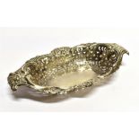 A SILVER BON BON DISH the oval shape with pierced decoration and embossed floral design to handles