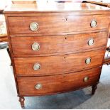 A GEORGE III MAHOGANY CHEST OF FOUR LONG GRADUATED DRAWERS with crossbanded decoration, on turned