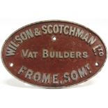 A CAST ALUMINIUM MANUFACTURER'S PLAQUE 'WILSON & SCOTCHMAN LTD / VAT BUILDERS / FROME, SOM[ERSE]