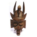 TRIBAL ART - AN AFRICAN CARVED WOOD WALL MASK 47cm high.