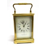 A BRASS CASED CARRIAGE CLOCK the enamel dial with Roman hour markers and Arabic minutes,