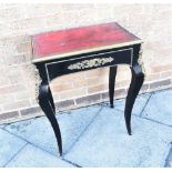 A FRENCH GILT METAL MOUNTED OCCASIONAL TABLE the rectangular top with gilt tooled red leather inset,